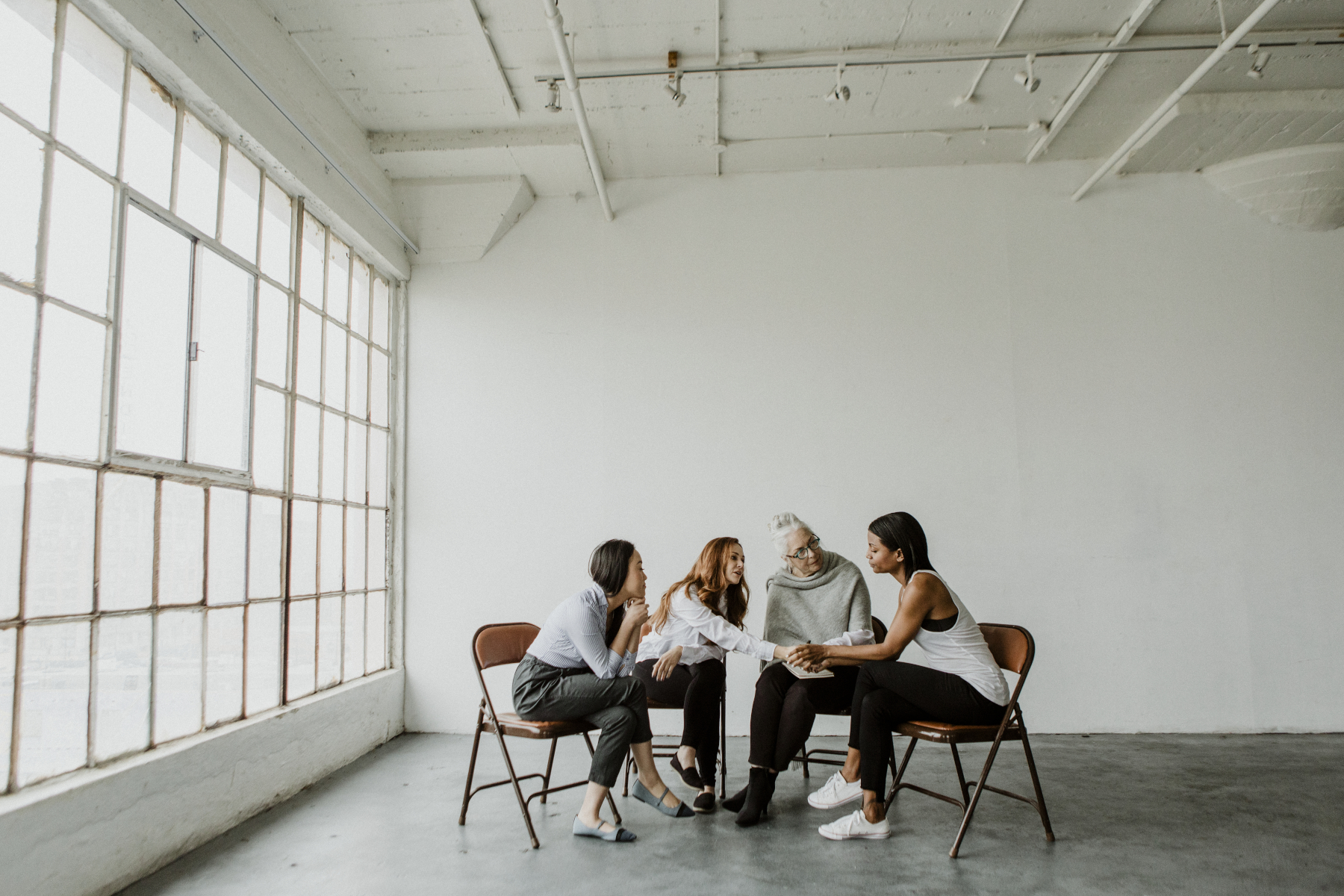 Diverse women in a supporting group session